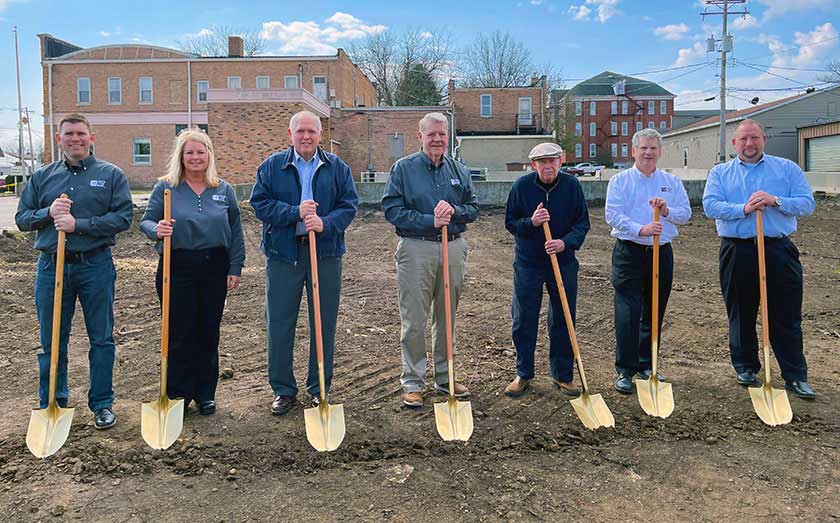 Picture of employees and board members holding golden shovels at the site of the new branch in Mount Morris.