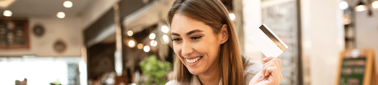 woman holding debit card in hand