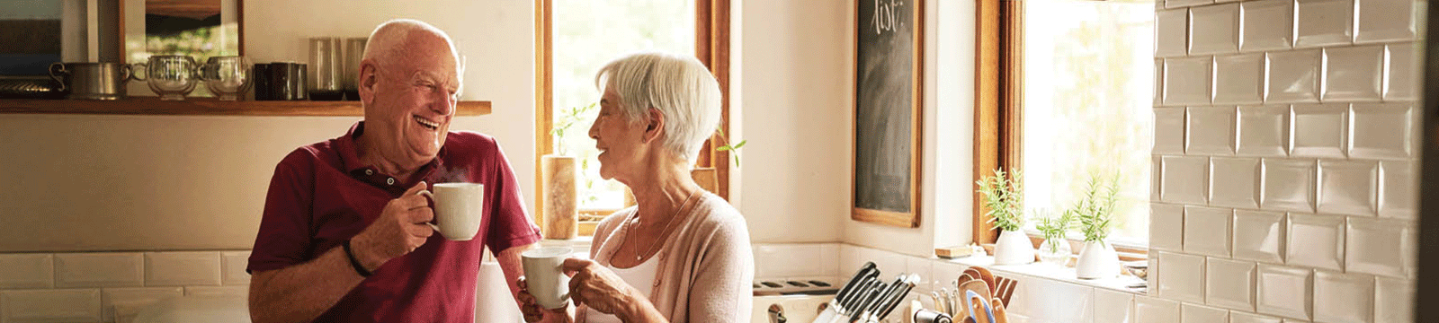 elderly couple in the kitchen having coffee